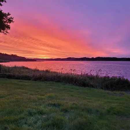 Black-painted Log House Overlooking Vejle Fjord *