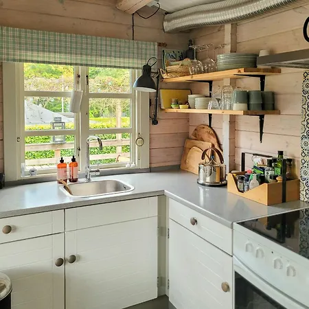 Black-painted Log House Overlooking Vejle Fjord *